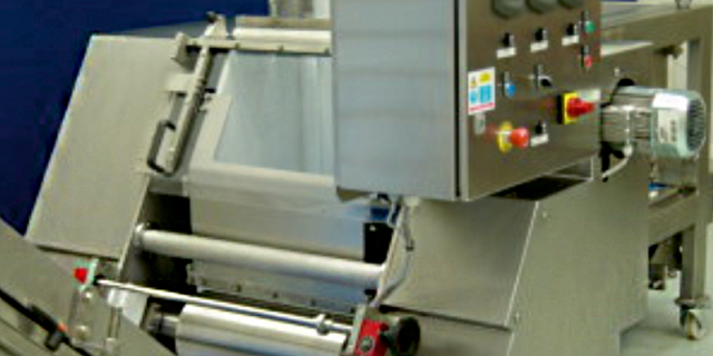 Automatic dough feed system from Arrow Design Services with options for adjustable dough gate from live bottom feeder, sheeting rolls, kibbler, chunker arrangements