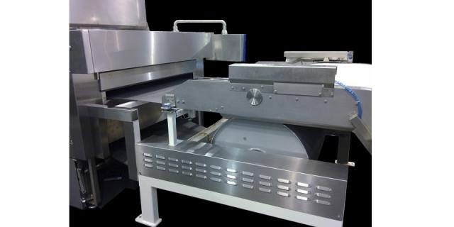 Oven feeding area with big diameter turning drum z-belt